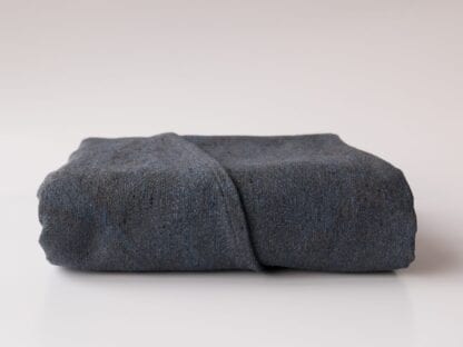 Disguise. A deep blue- and grey wrap made from 38% organic cotton 37% Silk, 25% wool and has a gsm of 310.